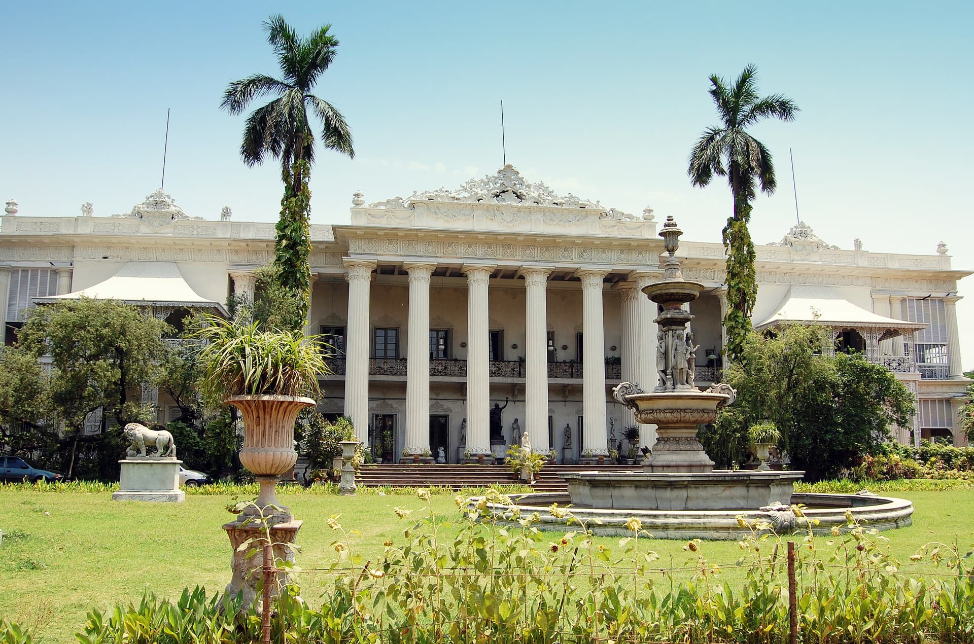 <p>The stately pillars and the lush gardens of the Marble Palace. (Picture by Kanad Sanyal, Wikimedia Commons)</p>