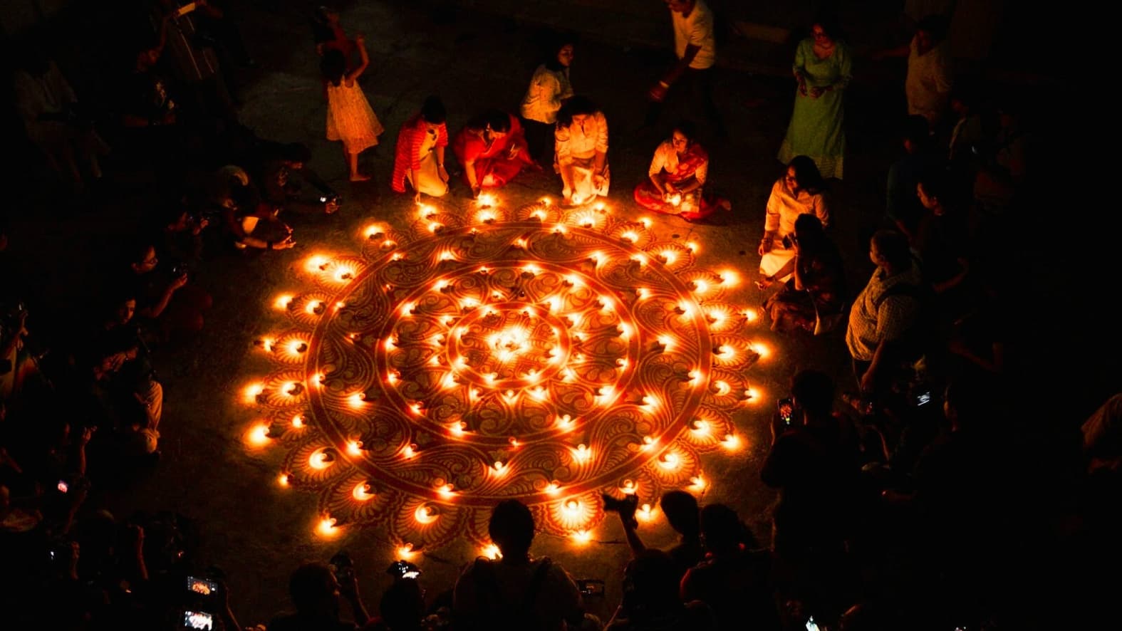 <p>Hundreds of diyas glow in a circle of light and devotion.</p>