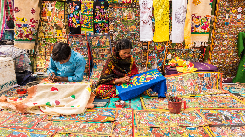 An artist with her patachitra creations. (Shutterstock) 