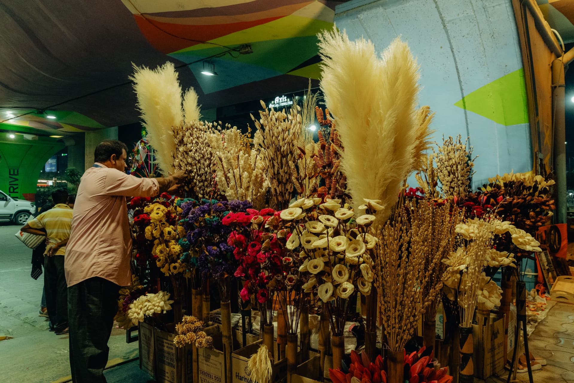 <p>Colourful dry flowers made from maize and palm leaves are on sale.</p>