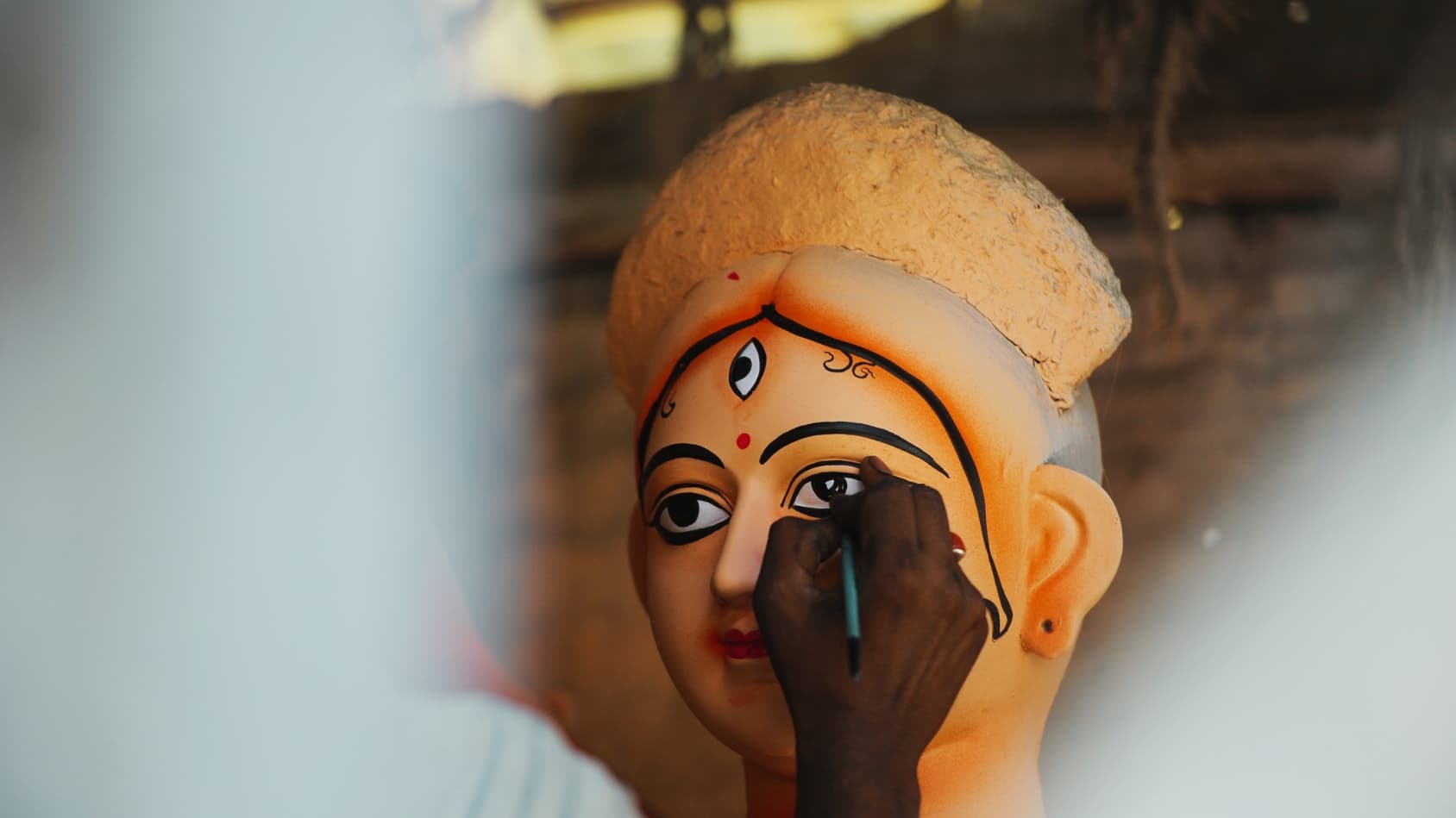 <p>In Kumortuli, artisans perform ‘Chokkhu daan’ — bestowing the eyes on the idol of Goddess Durga, signifying her life and presence.</p>
