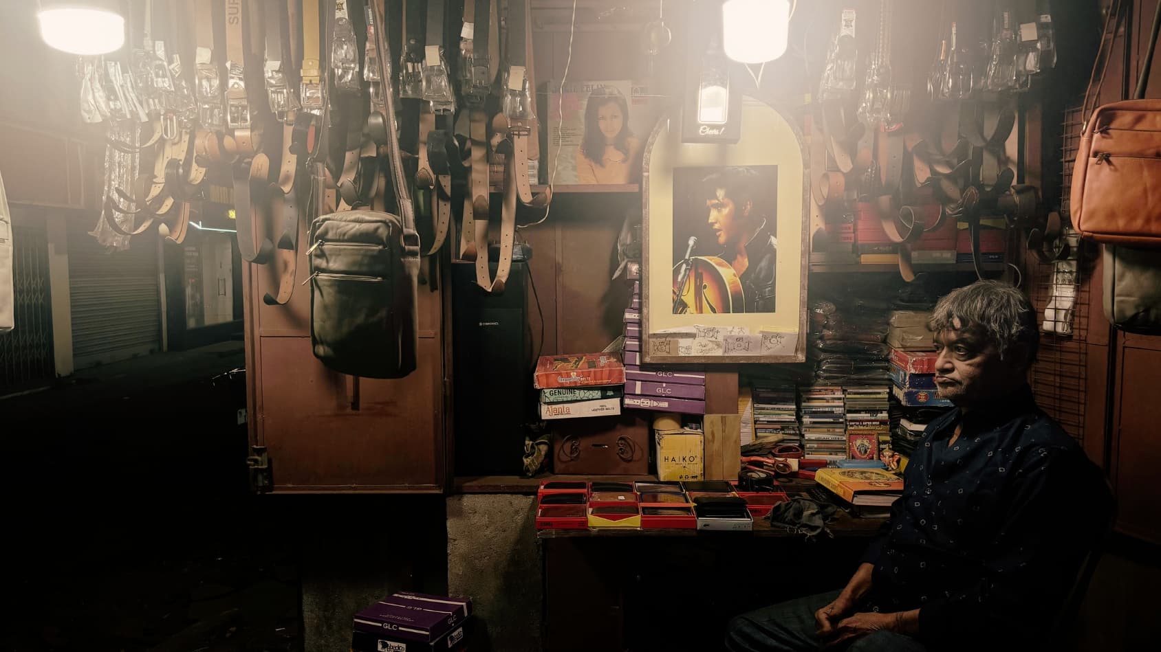 <p>A gentleman sells rugged&nbsp;leather wallets, belts and sling bags alongside an unexpected collection of old&nbsp;cassettes&nbsp;and&nbsp;CDs.&nbsp;</p>